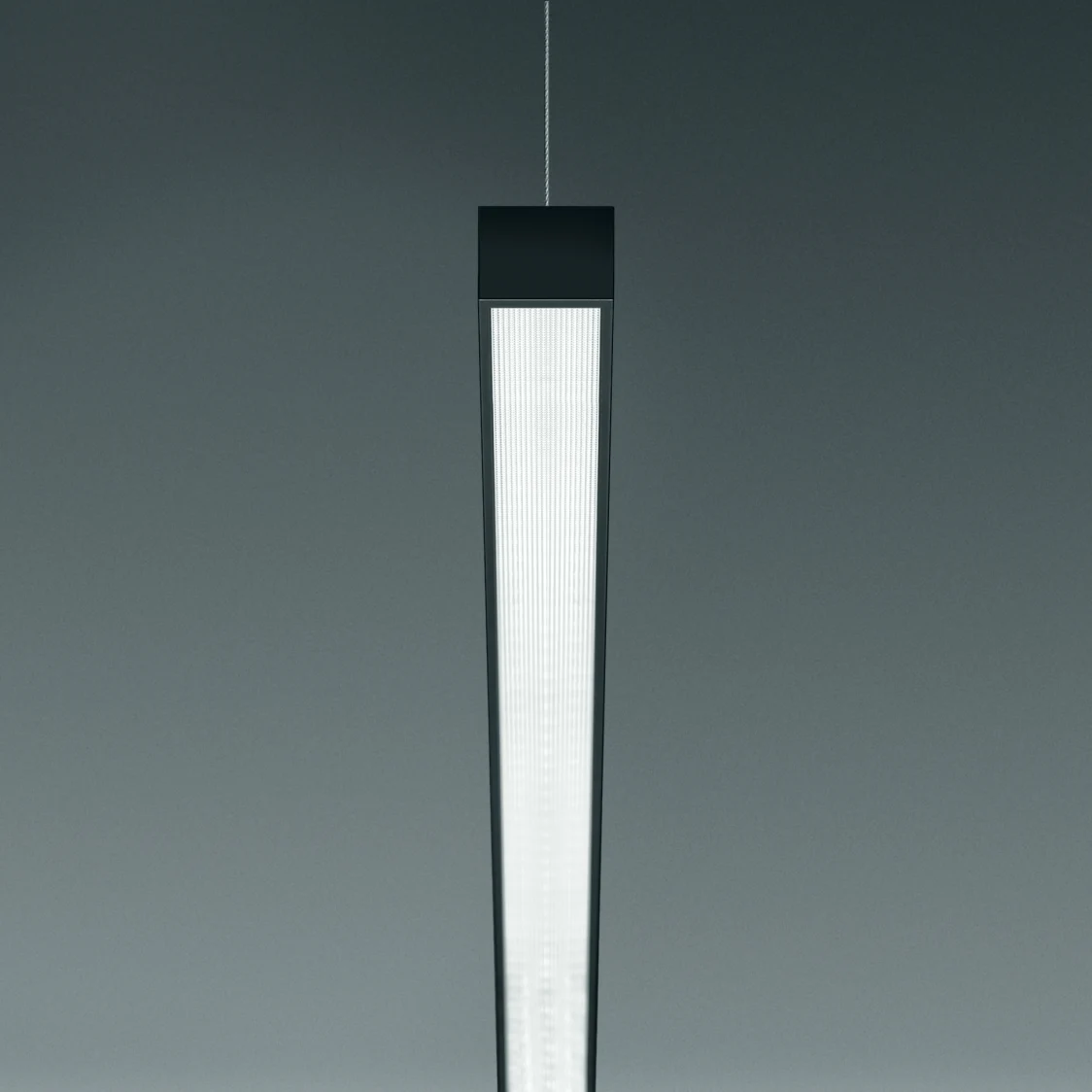 The Supersystem Inline pendant luminaire offers uniform lighting in a modern design against a neutral background.
