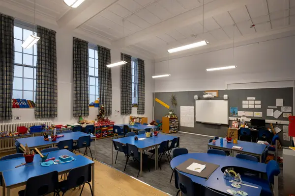 Primary school classroom with dusk natural light and linear lighting