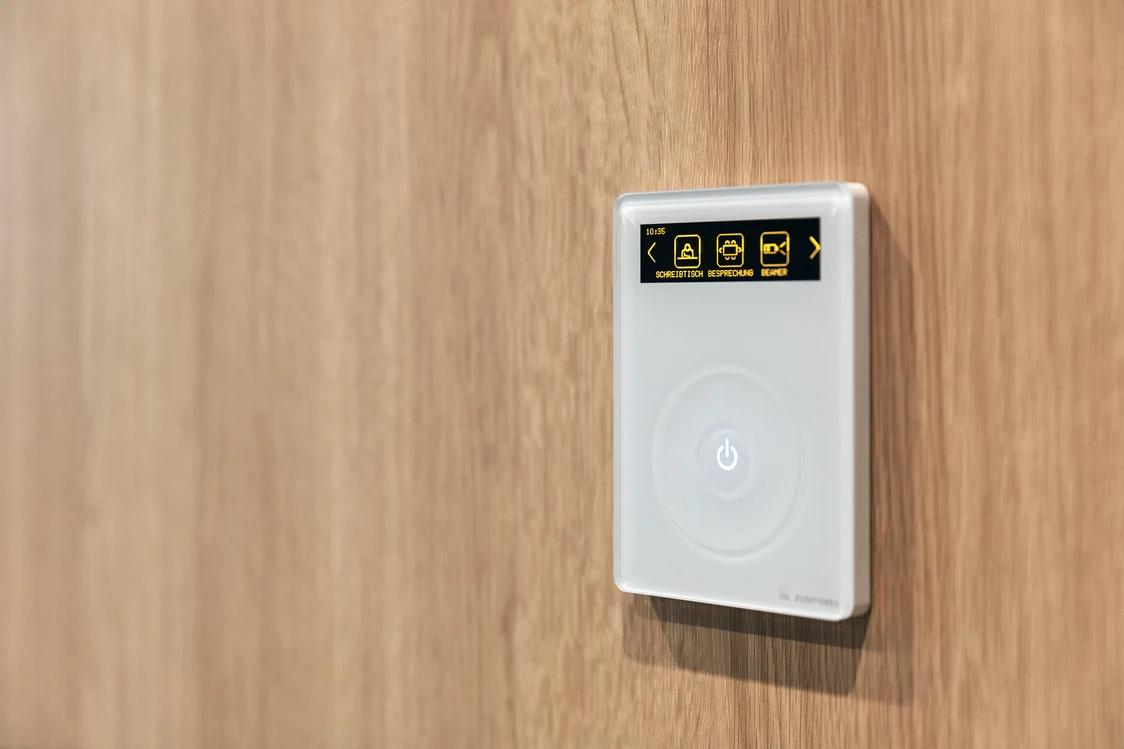 The Score-Alarm Superology system component is mounted on a wooden wall