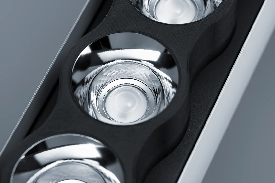 Close-up of IZURA Zumtobel luminaire reflectors made from sustainable biocomposite material