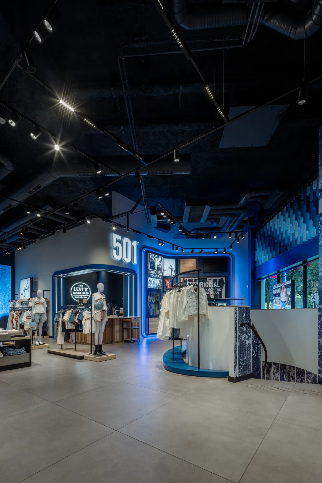 Levi Strauss flagship store with innovative Zumtobel lighting, blue LED accents, and modern presentation of denim collections.