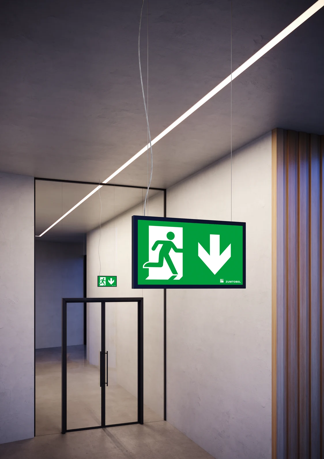 Gros plan sur deux luminaires de signal d’évacuation SMARTSIGN de Zumtobel dans un couloir moderne, séparés par une porte vitrée — une intégration élégante dans l'architecture.