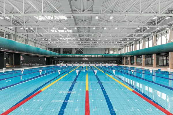 Indoor olympic sized swimming pool, with natural light coming through