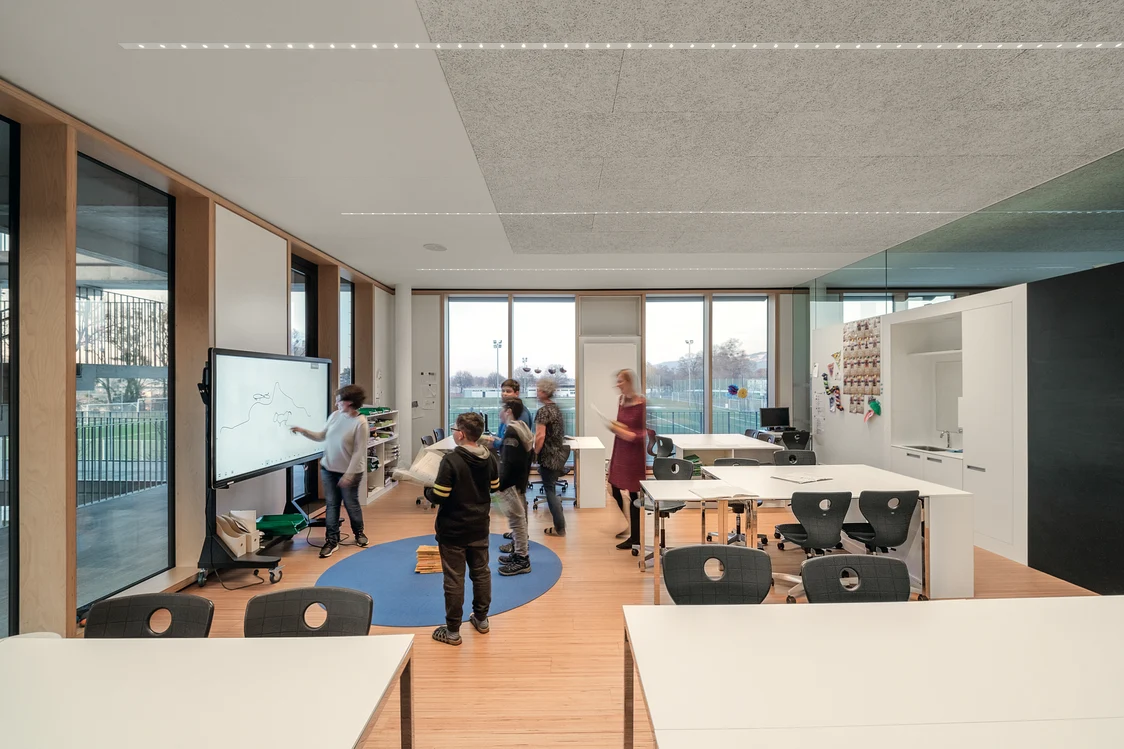A focused child studying with the teacher