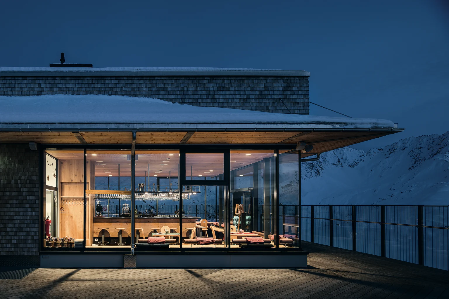 Illuminated modern building in snowy mountain landscape at night Zumtobel