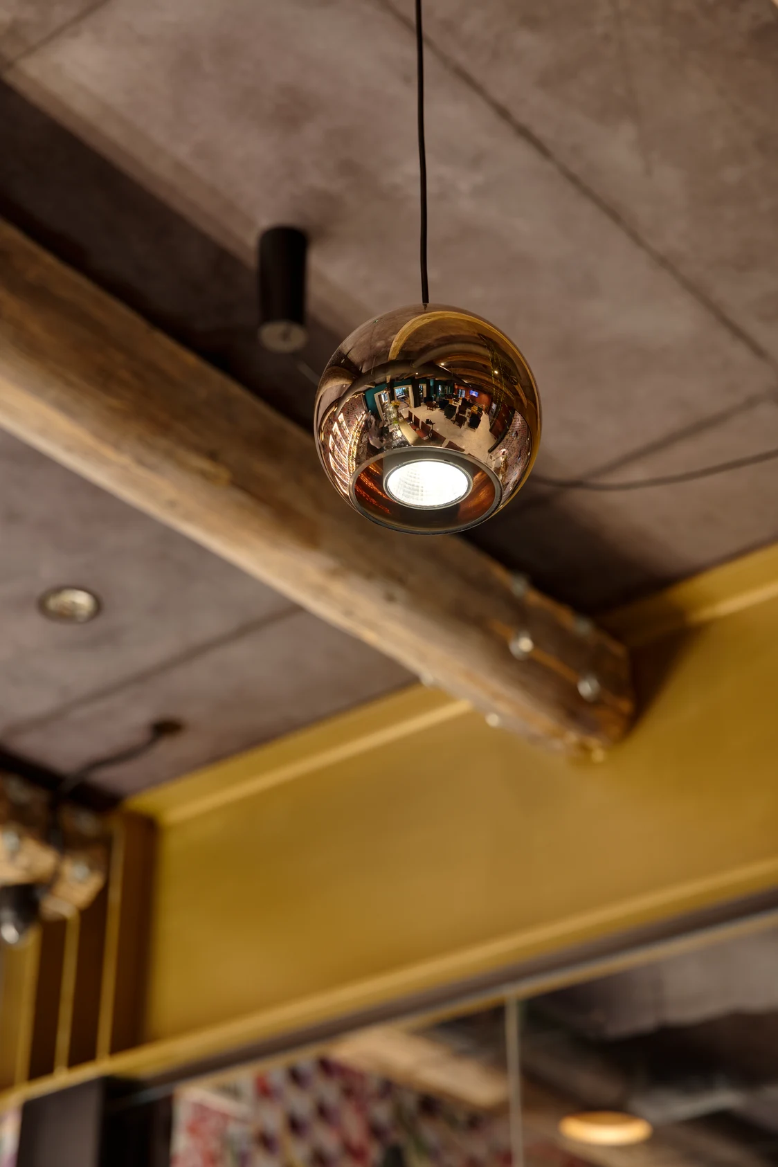 The SCONFINE pendant luminaire features a clear, round glass shade that emits warm white light for a subtle room ambiance.