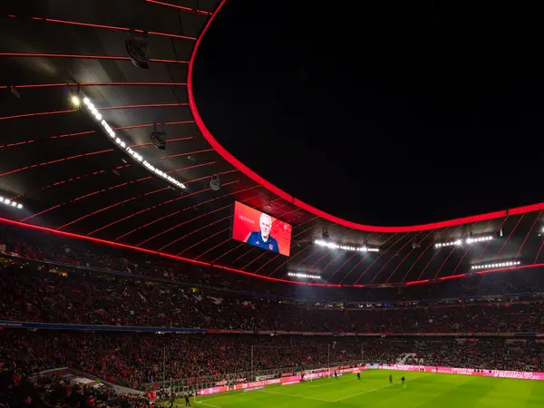 Stadium with linear lighting in red illuminating the stands