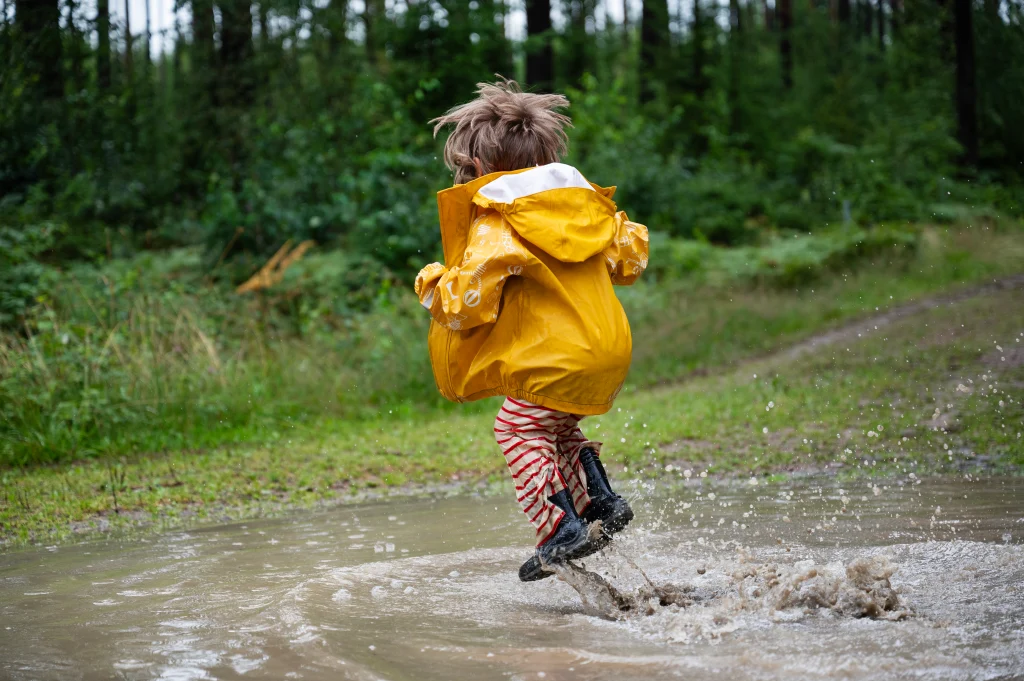 Girl jumping in puddle