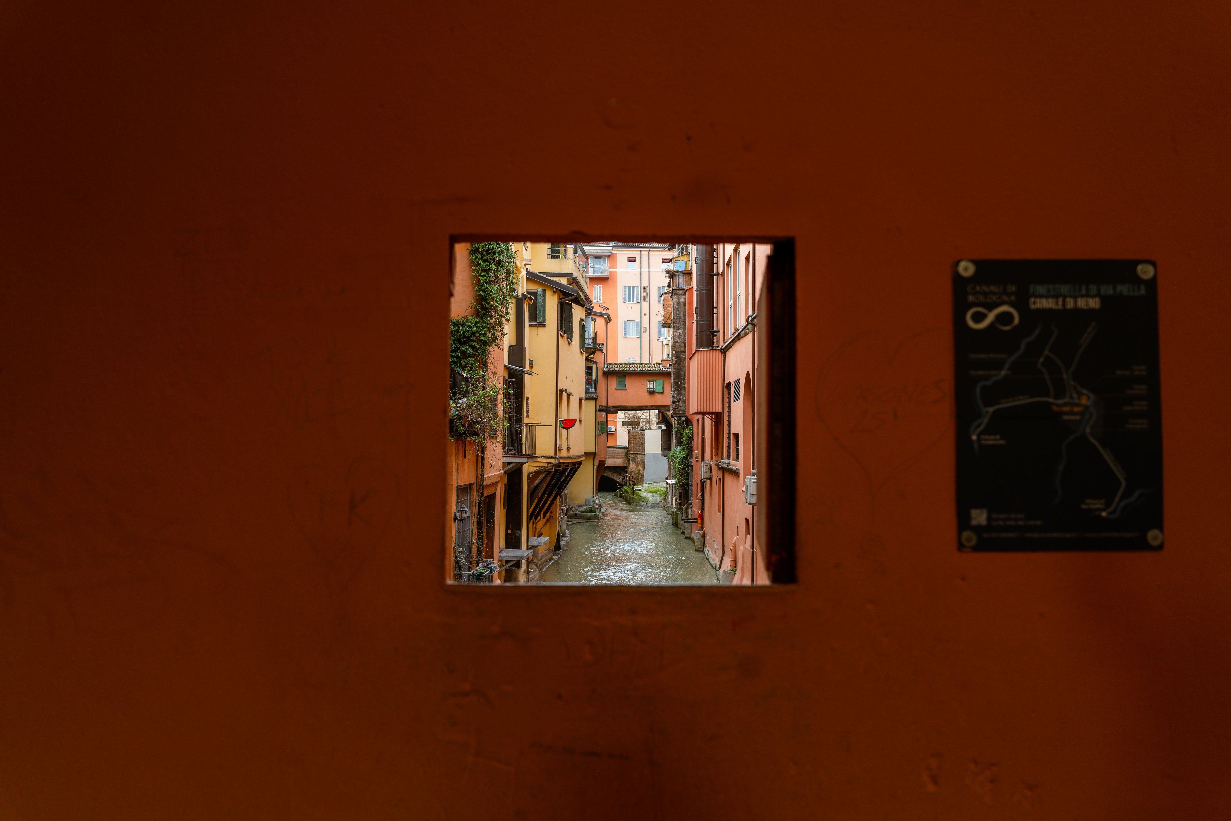 Ein Fenster in einer Hauswand mit Blick auf einen Kanal