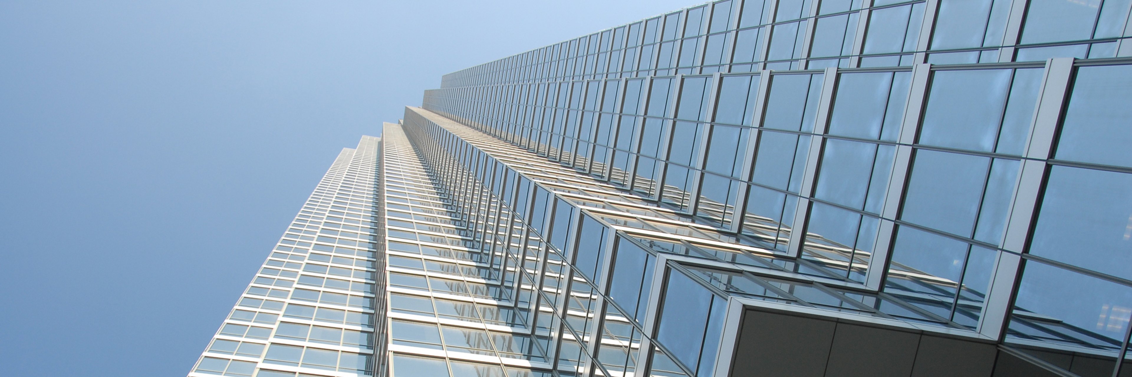 A skyscraper rising high into a clear blue sky