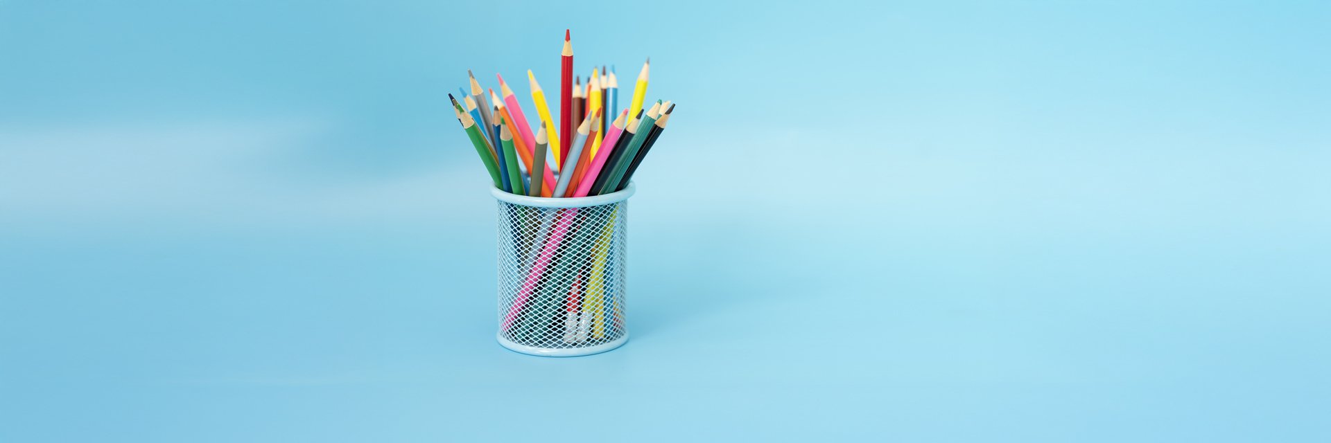 Colored crayons upright in a jar.