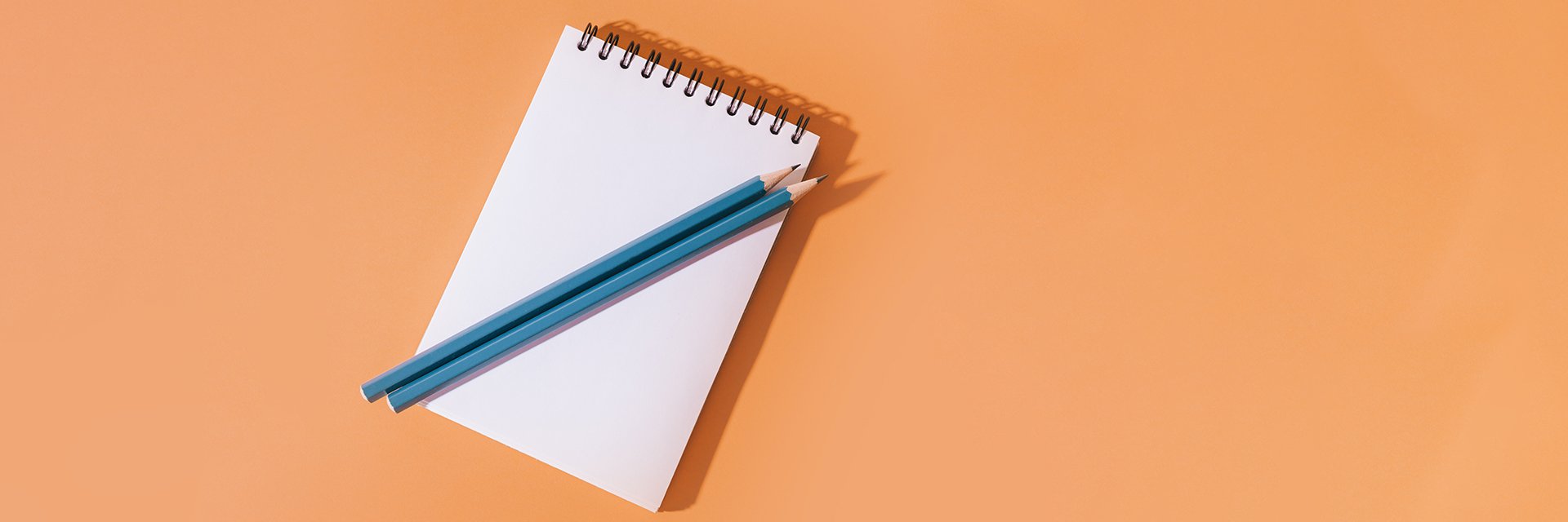 A notepad and pen, ready for someone to take notes.