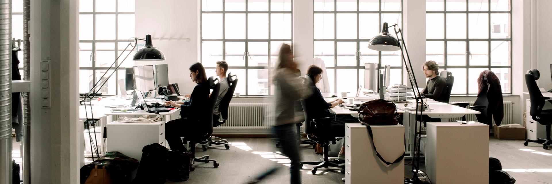 Professional working at modern workstations