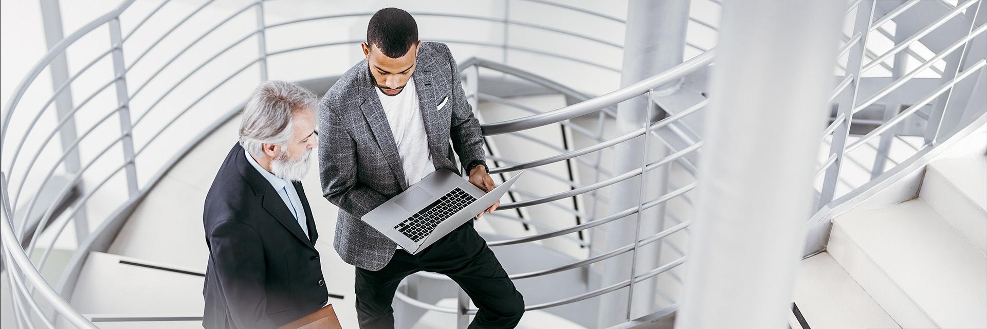 Two people on a modern office staircase