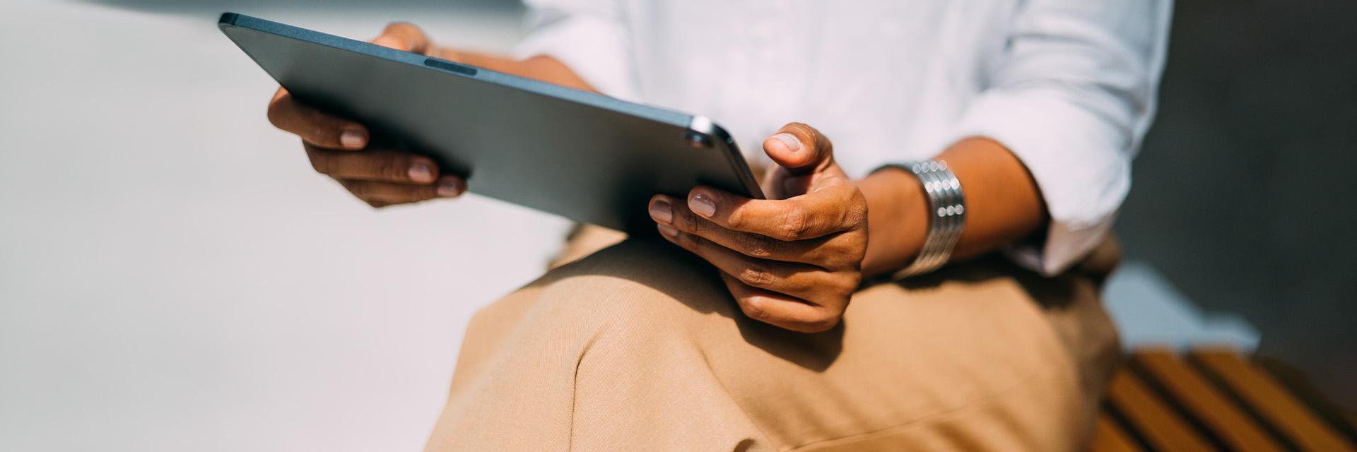 Hands holding a laptop