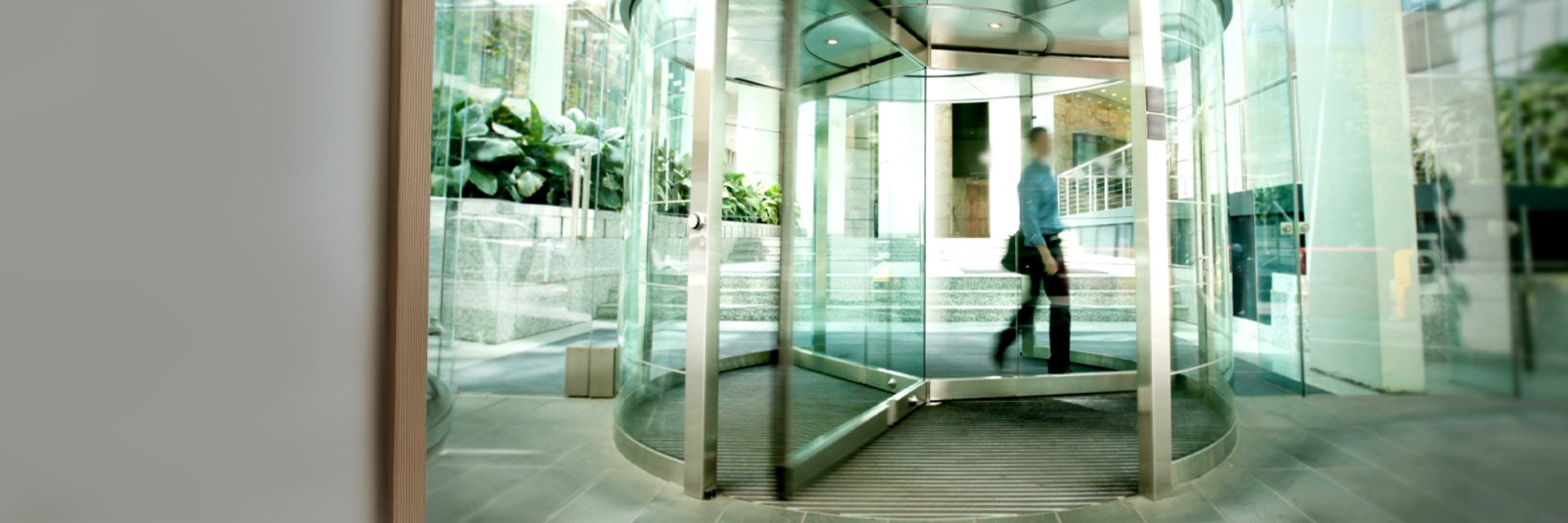 People walking in a modern office building with glass walls