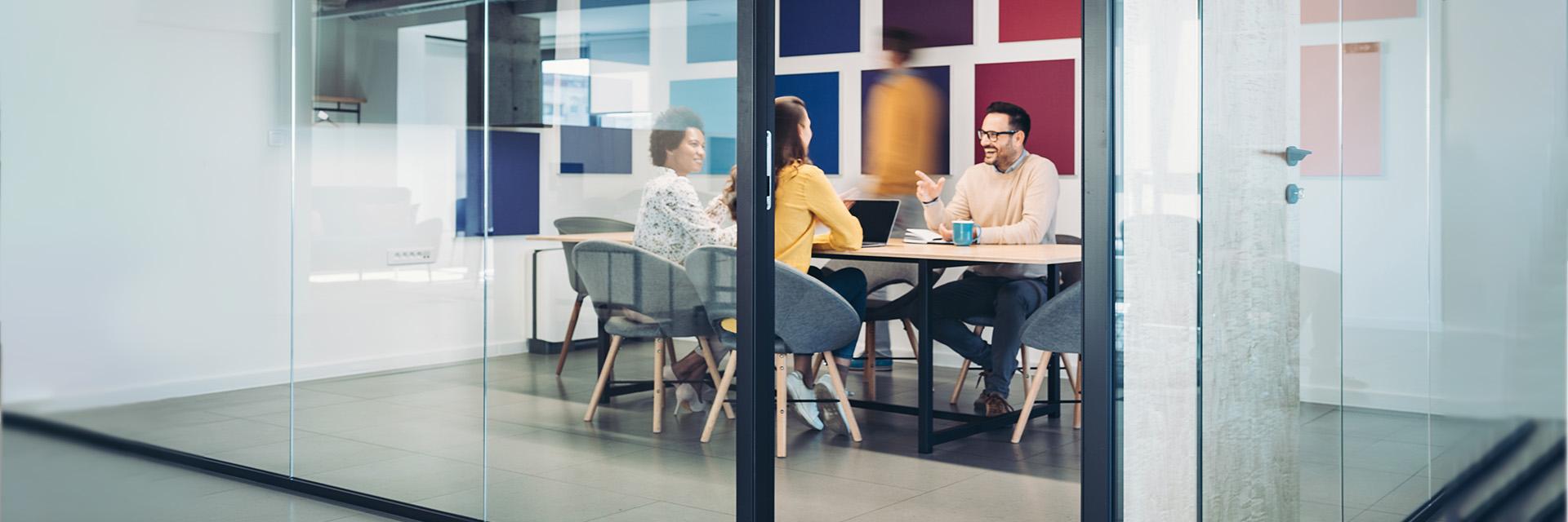 People laughing at a work table