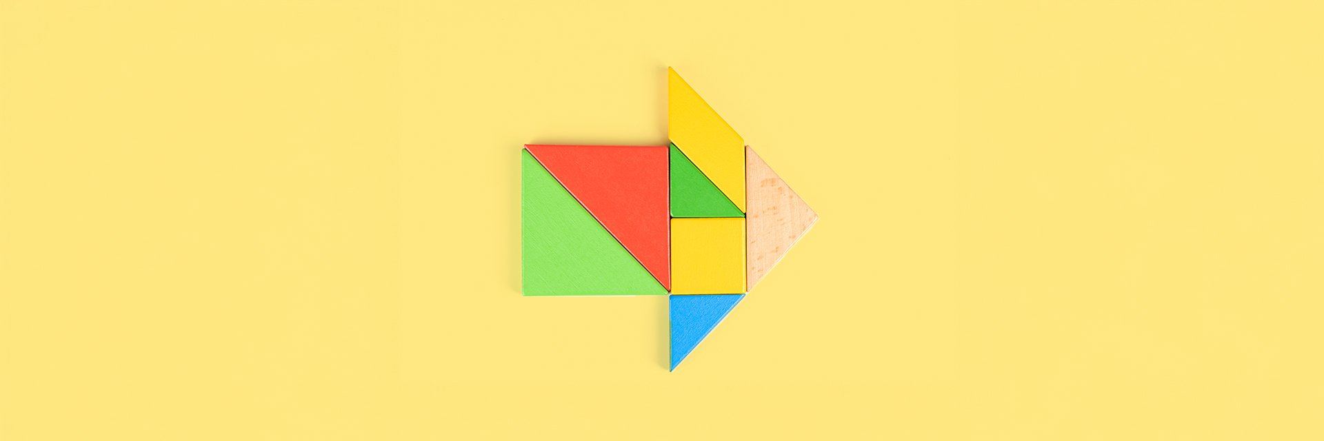 Puzzle pieces form an arrow pointing forward.