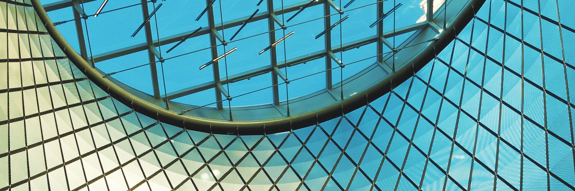 A circular window on the top of a modern office building