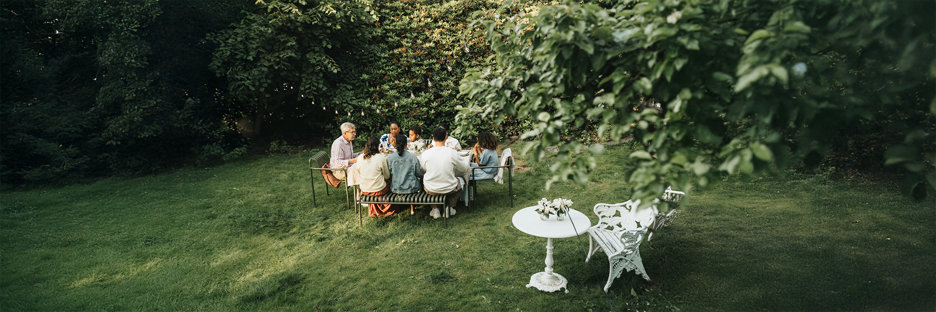 family-having-meal-yard