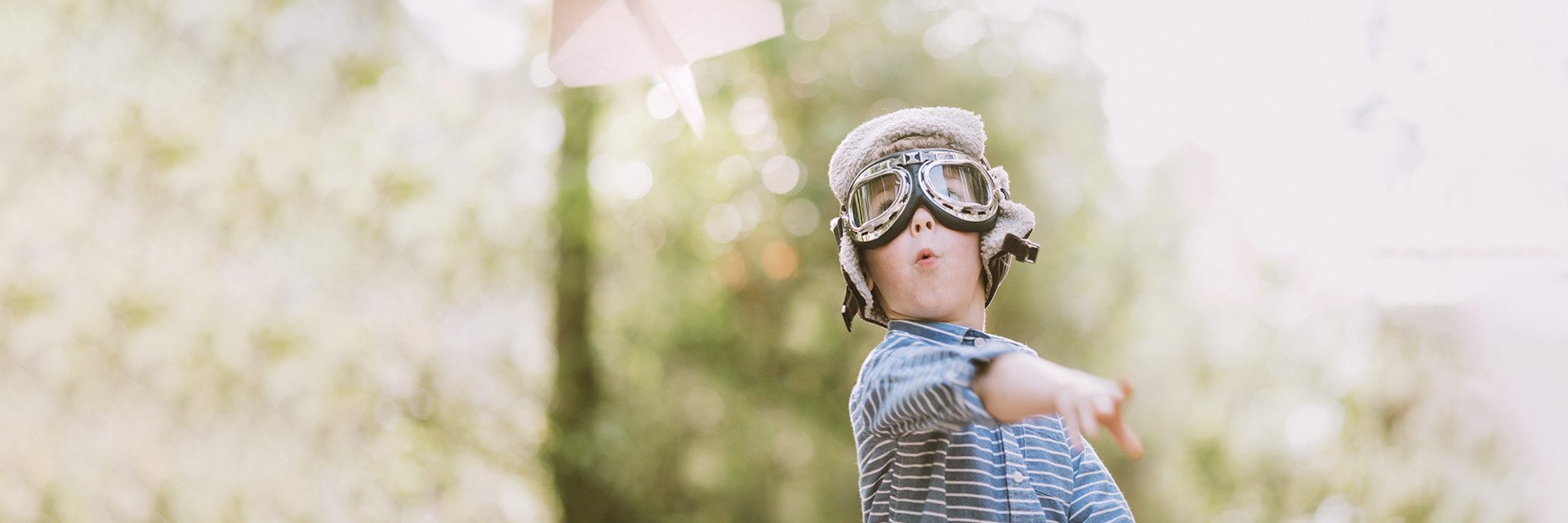 boy-flying-paper-airplane