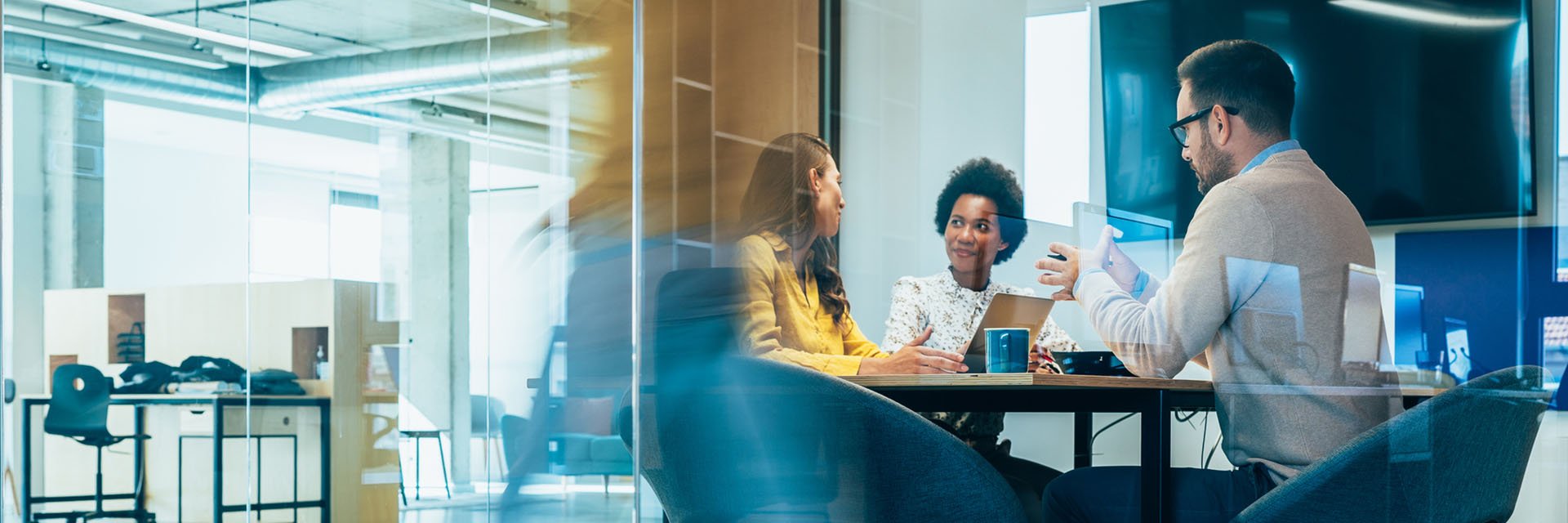 People working around a conference table in a modern office.