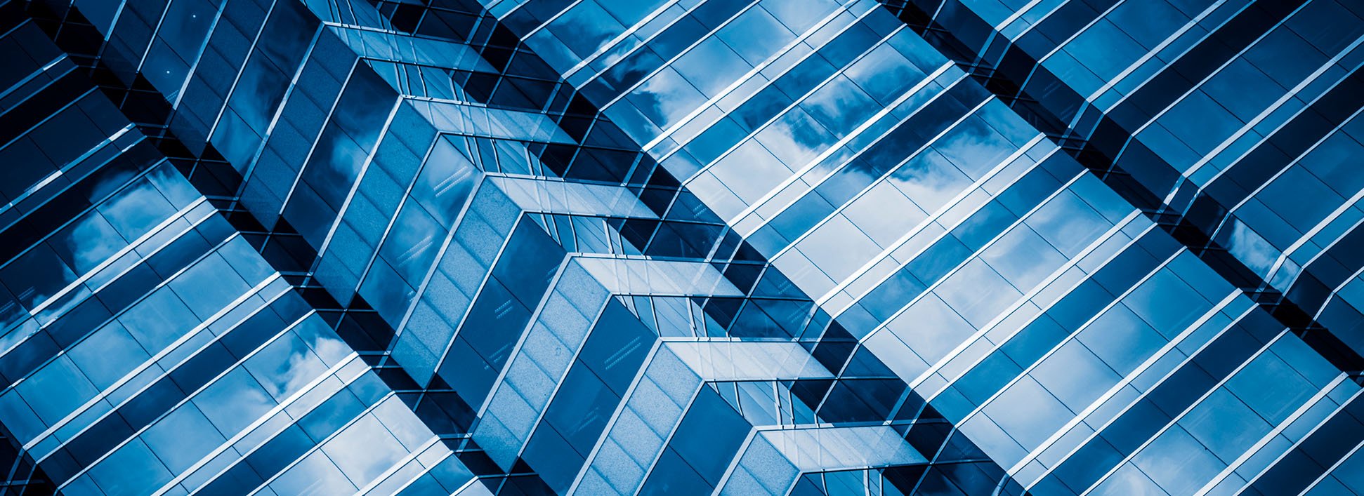 Two people chat in a modern office lounge