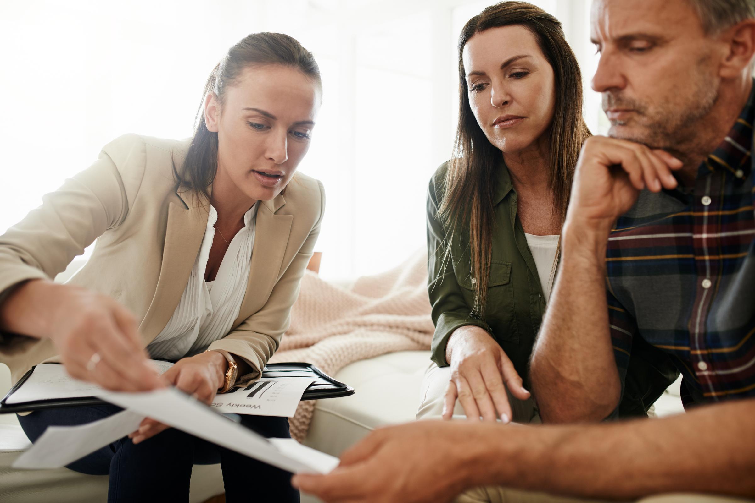 Mature couple getting advice from their financial consultant at home