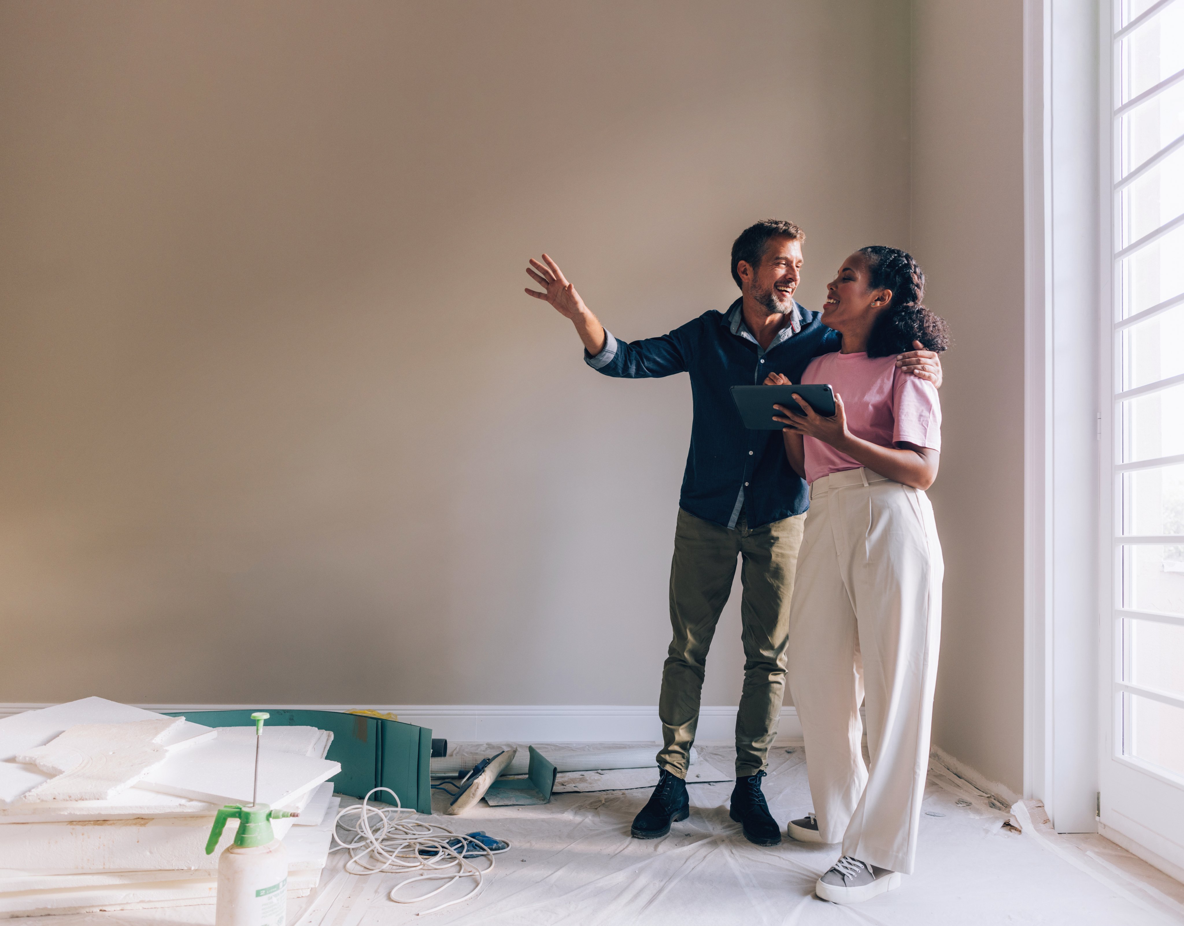 a young couple plan how to decorate their new home