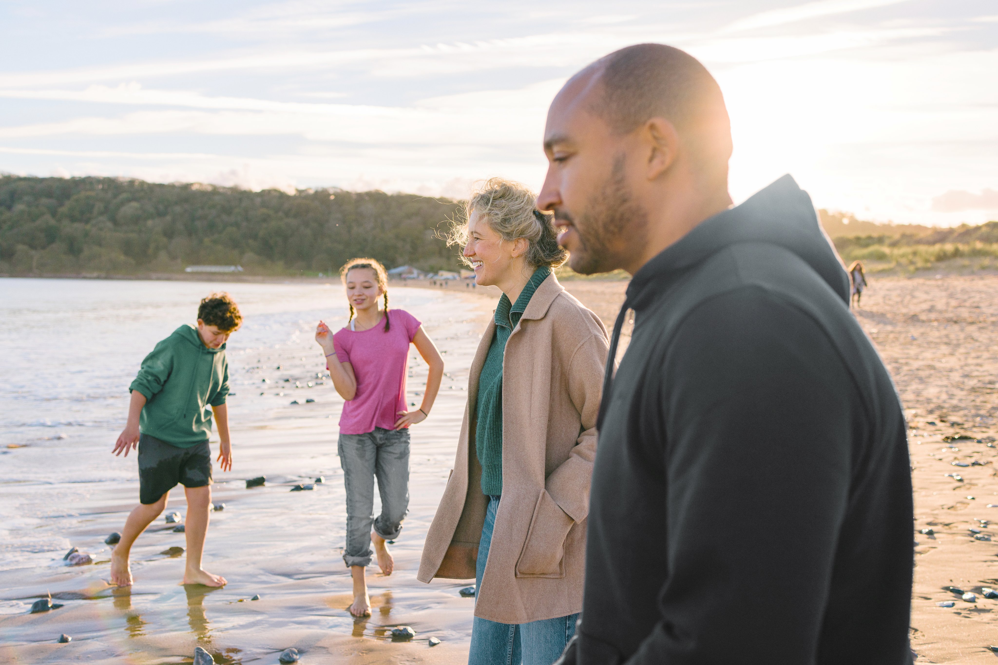 Family walk on the beach together