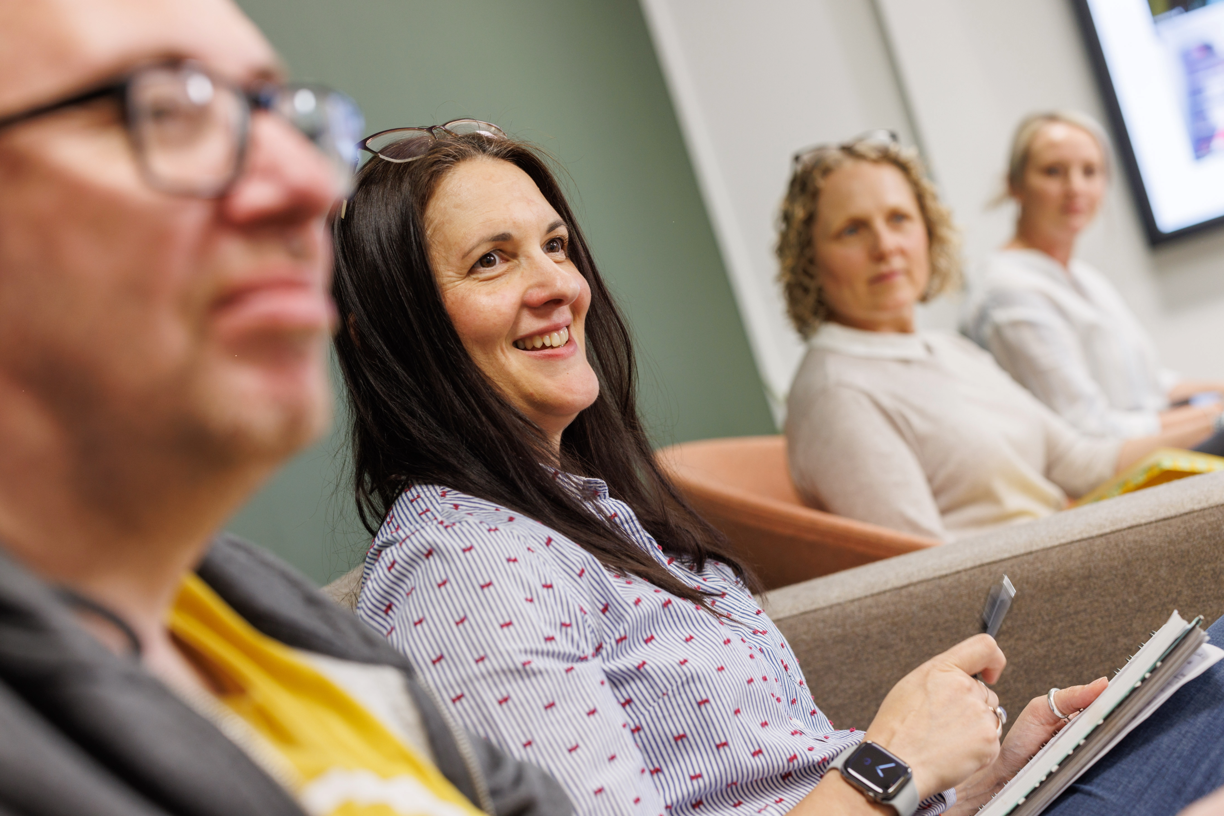 A woman in the office setting  smiling 