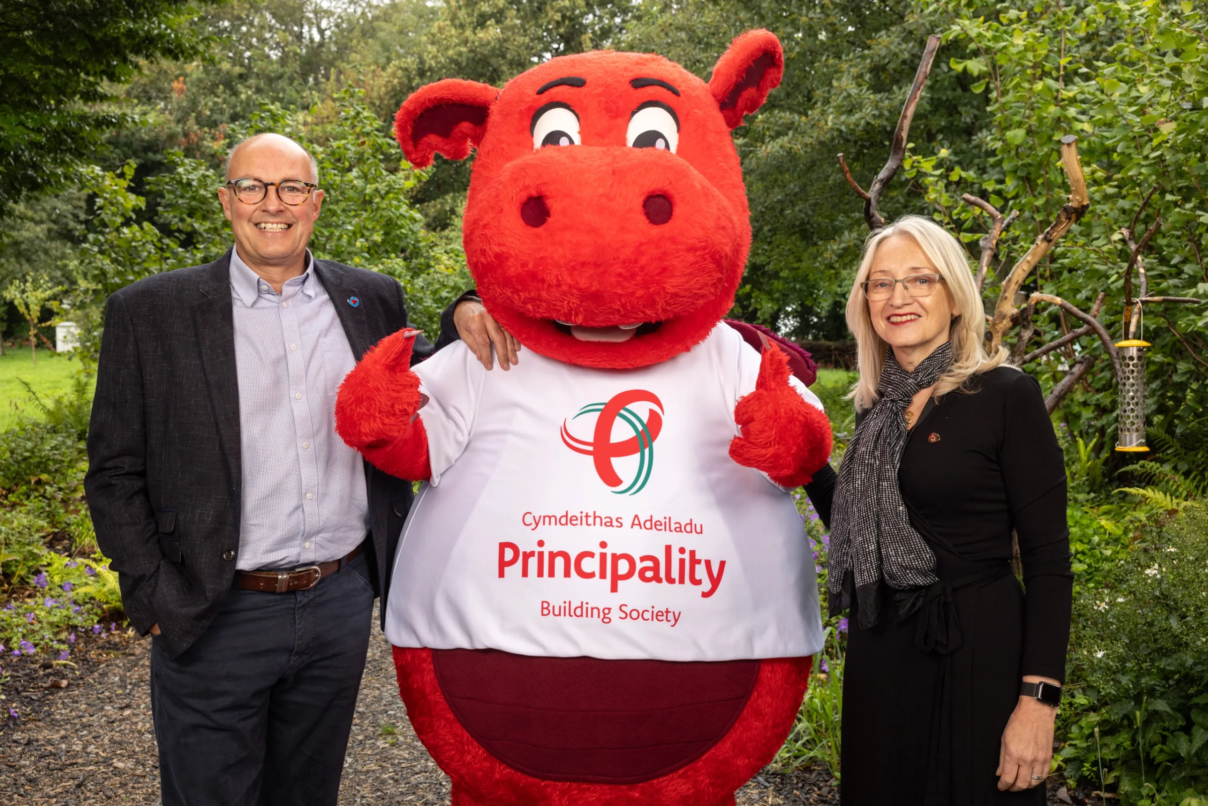 Photo of Dylan the dragon with our charity partners.