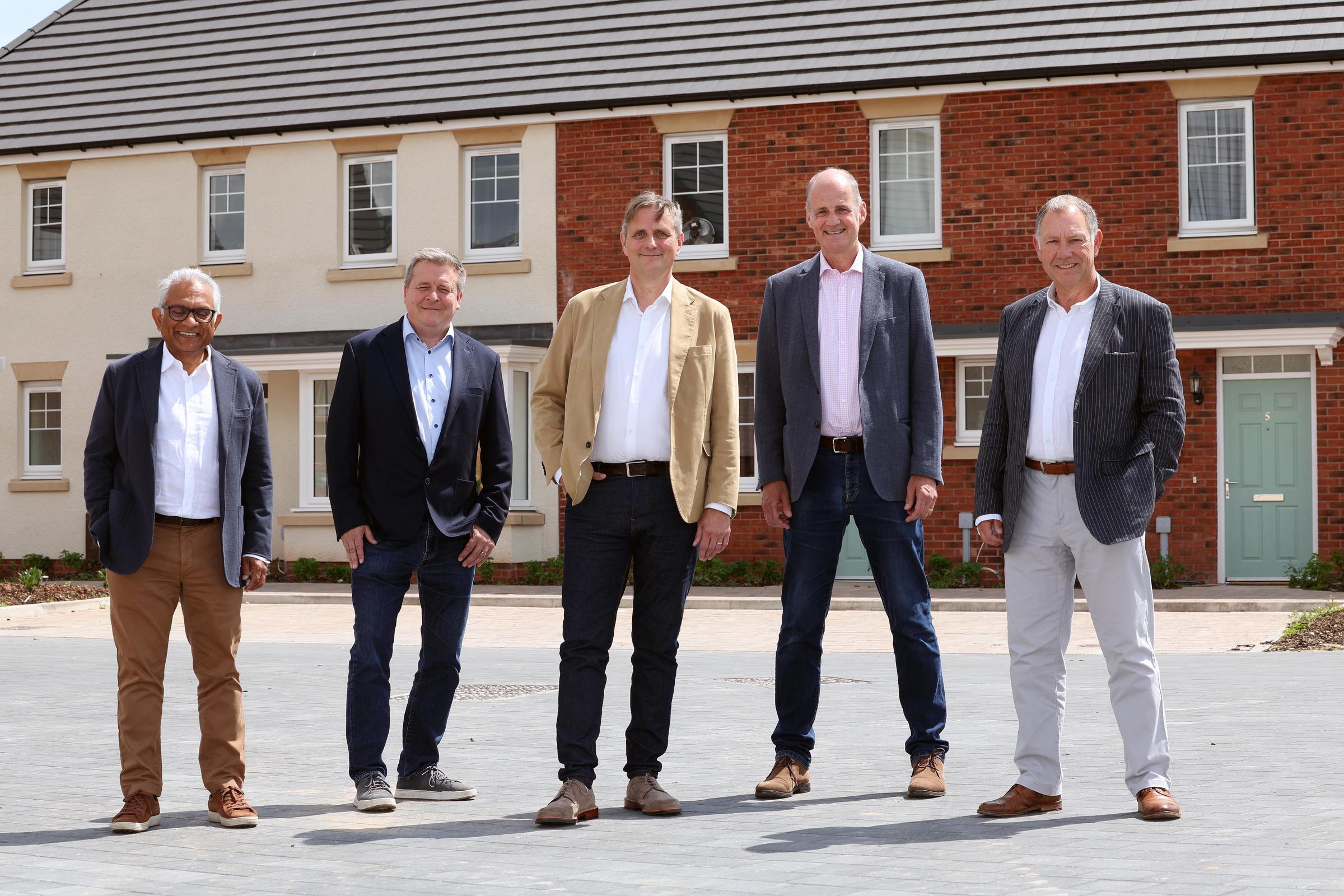 Group stood outside new houses