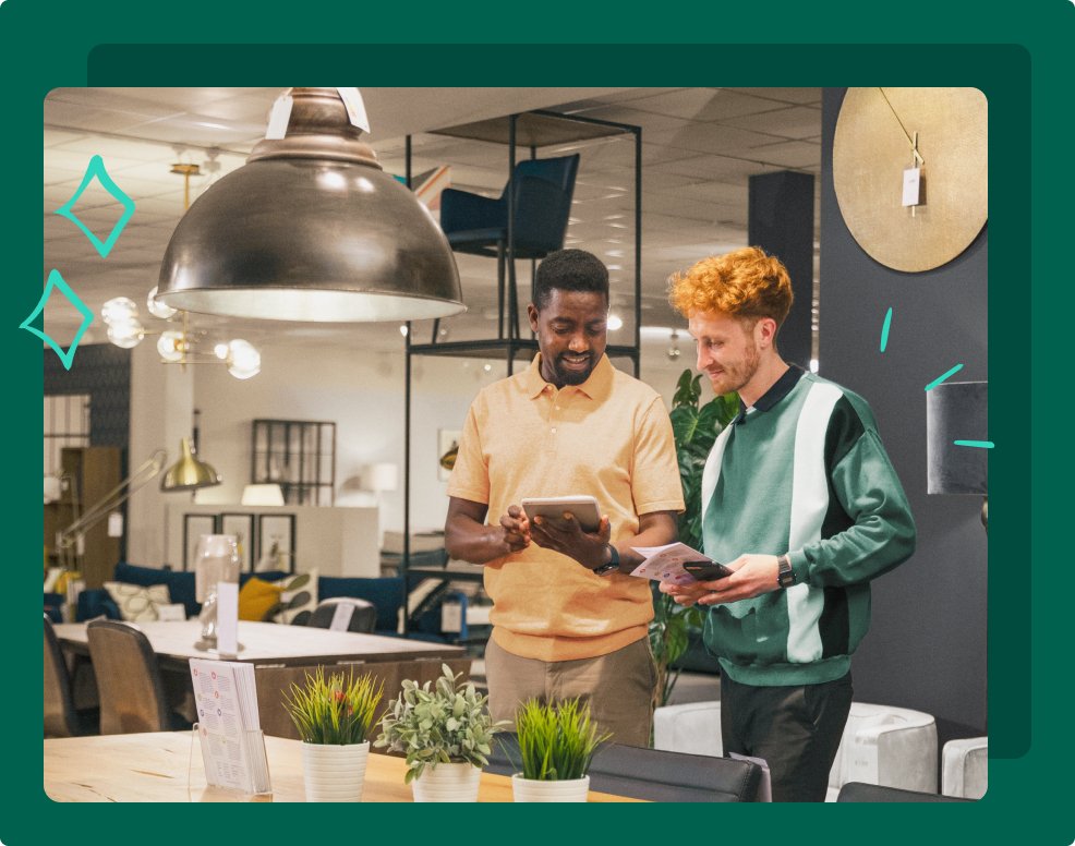 Two men look at an ipad while shopping in a showroom