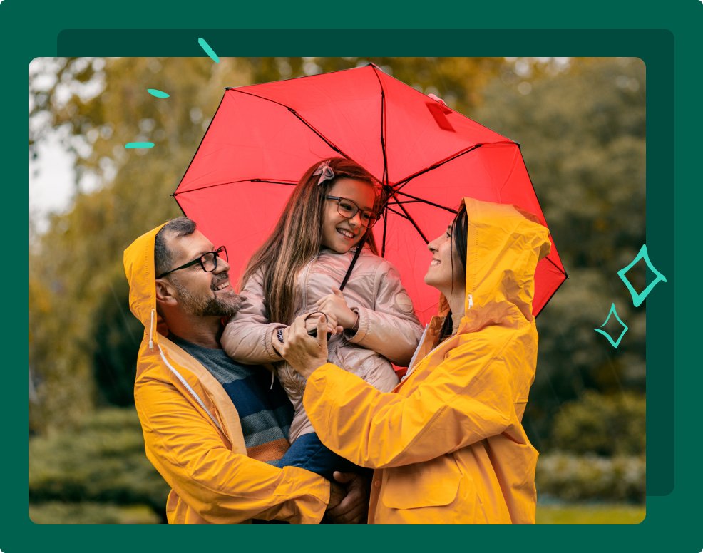 Family of three in raincoat enjoying together in city park.