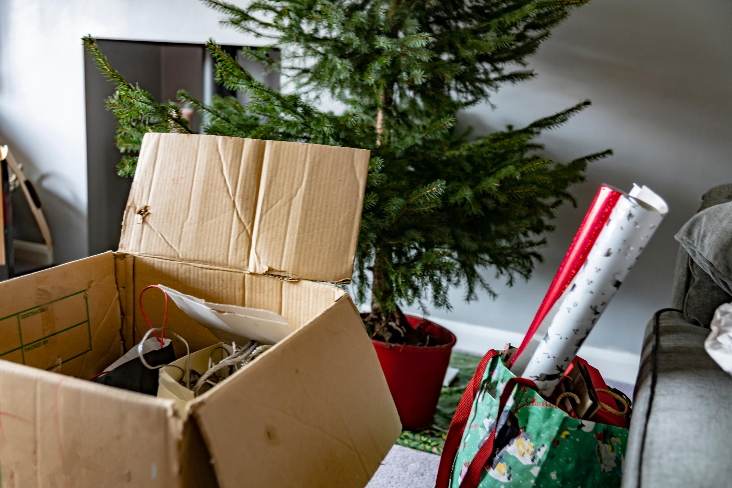 aubles, lights, Christmas cards and wrapping paper being taken down and unpacked 