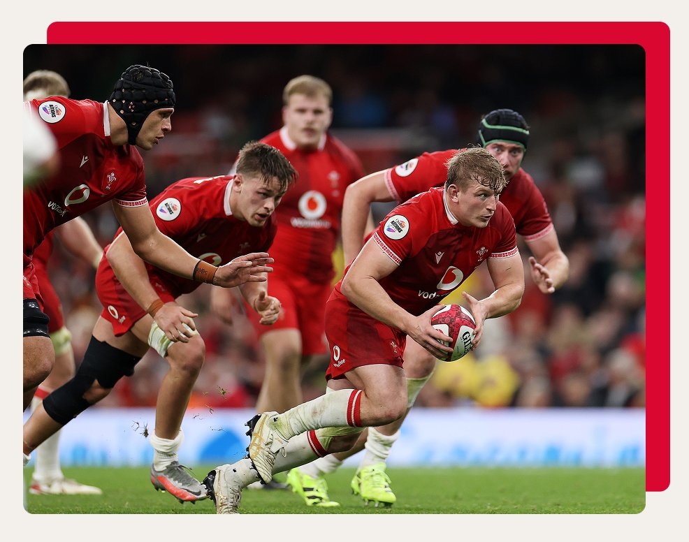 Welsh rugby players running to score a try