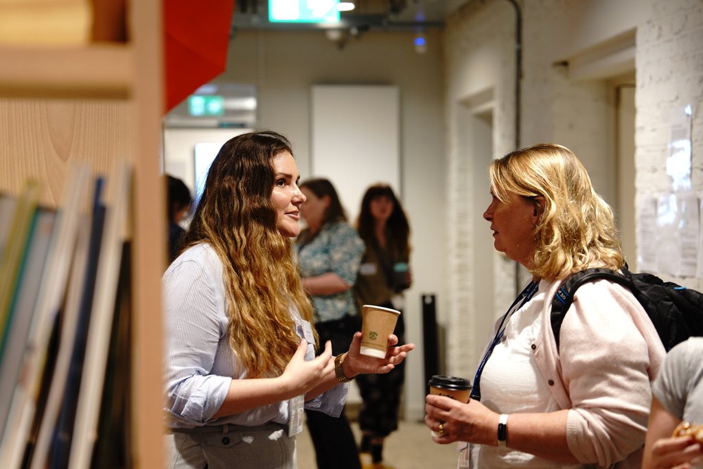 Two members of Anna Freud staff having a conversation in an office.                   
