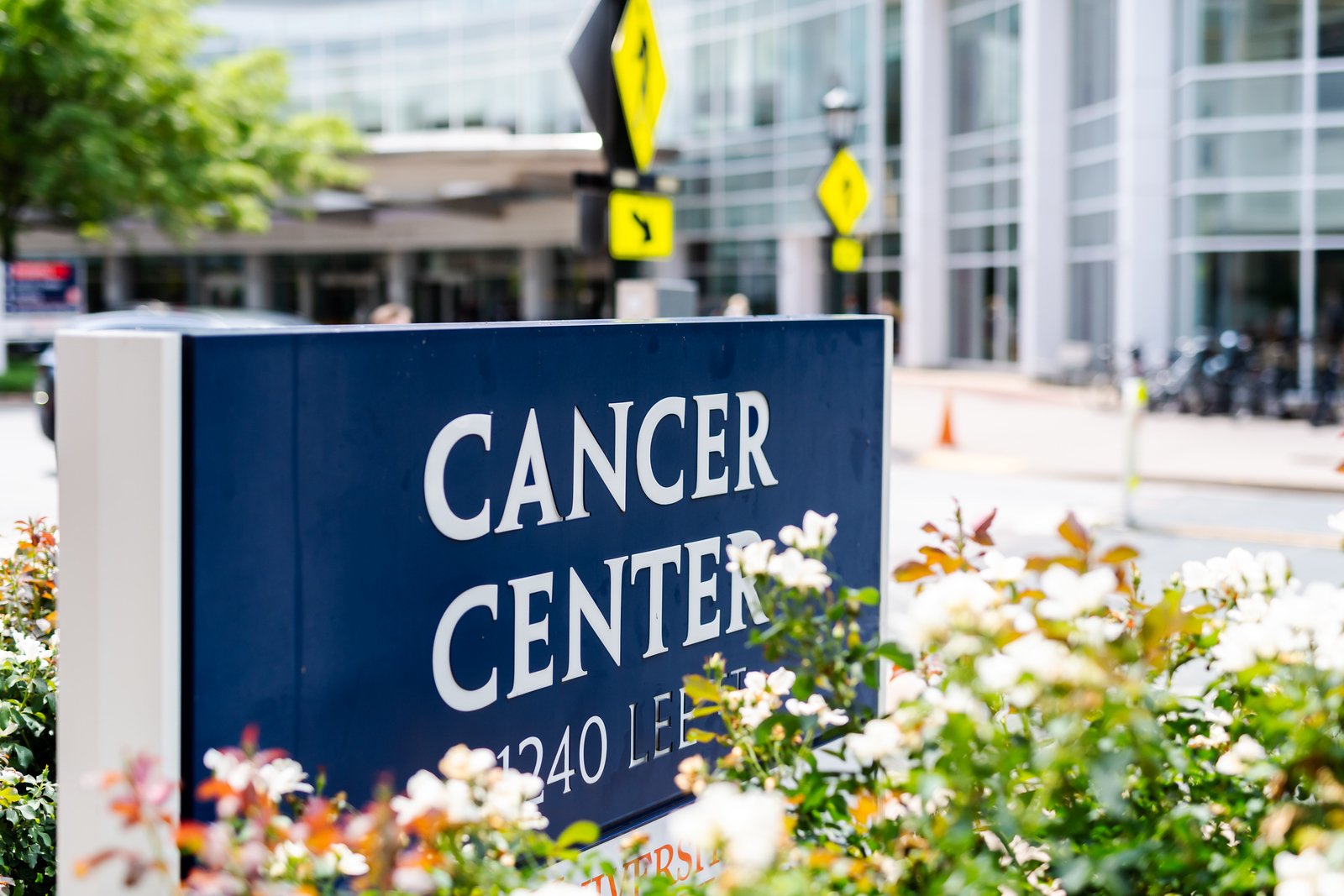 Exterior cancer center sign framed by flowers