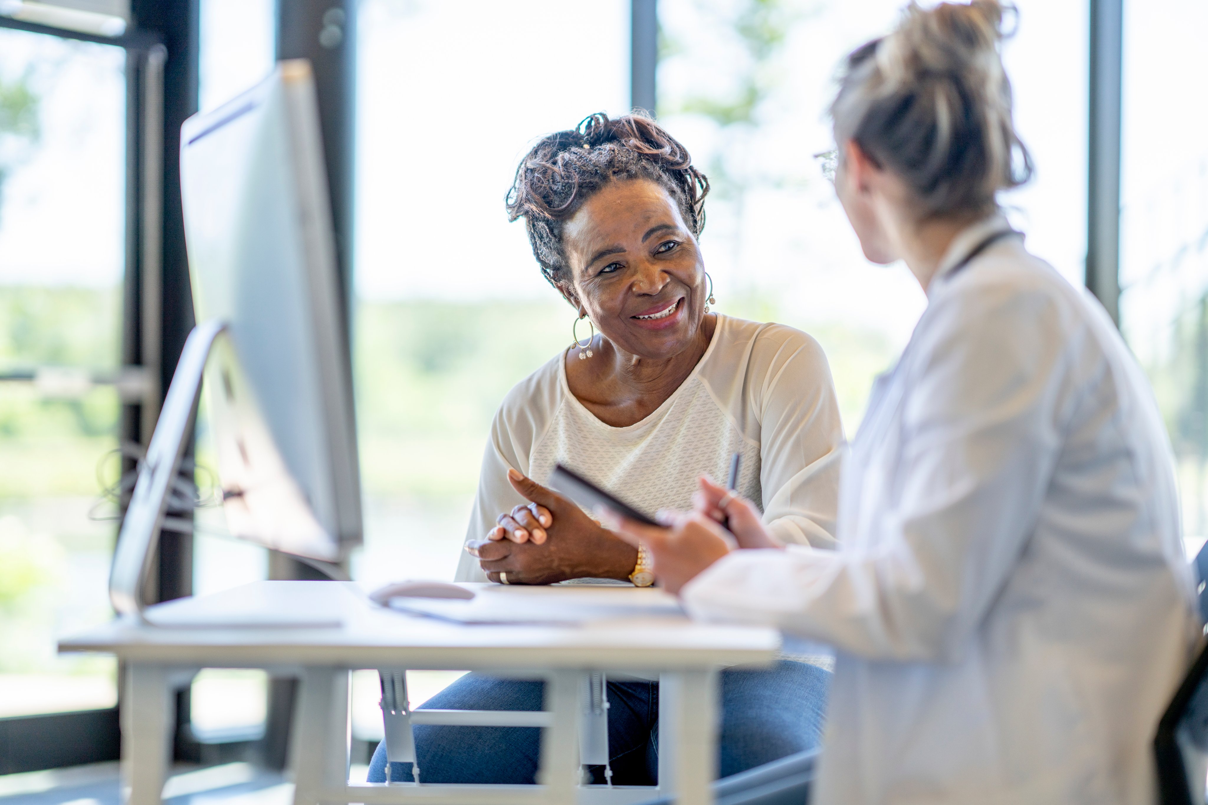 A clinician talks with a patient
