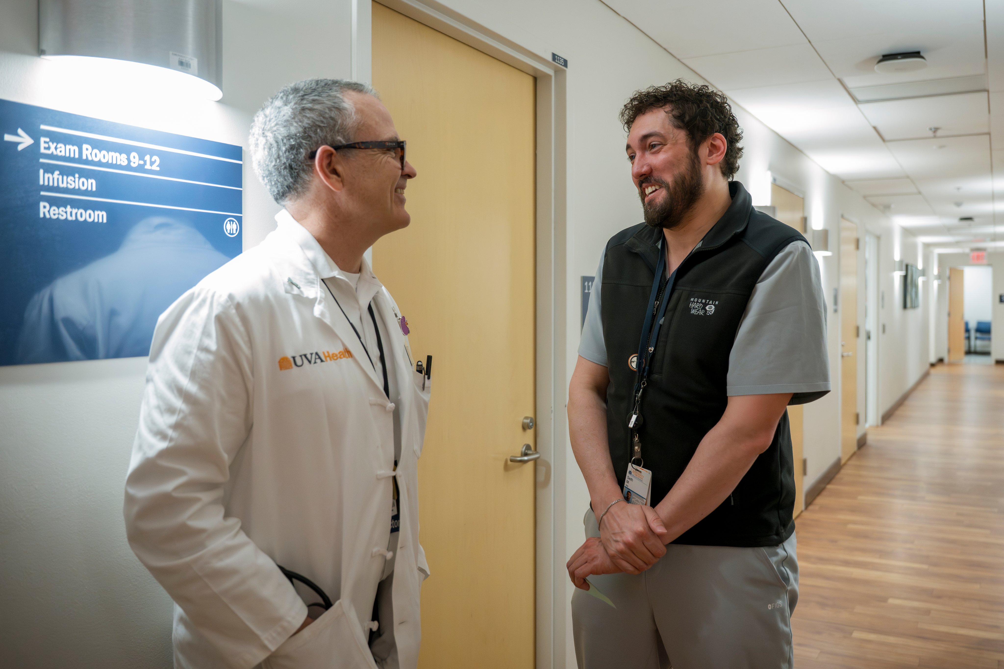 Two UVA Health transplant providers talking together in a hallway