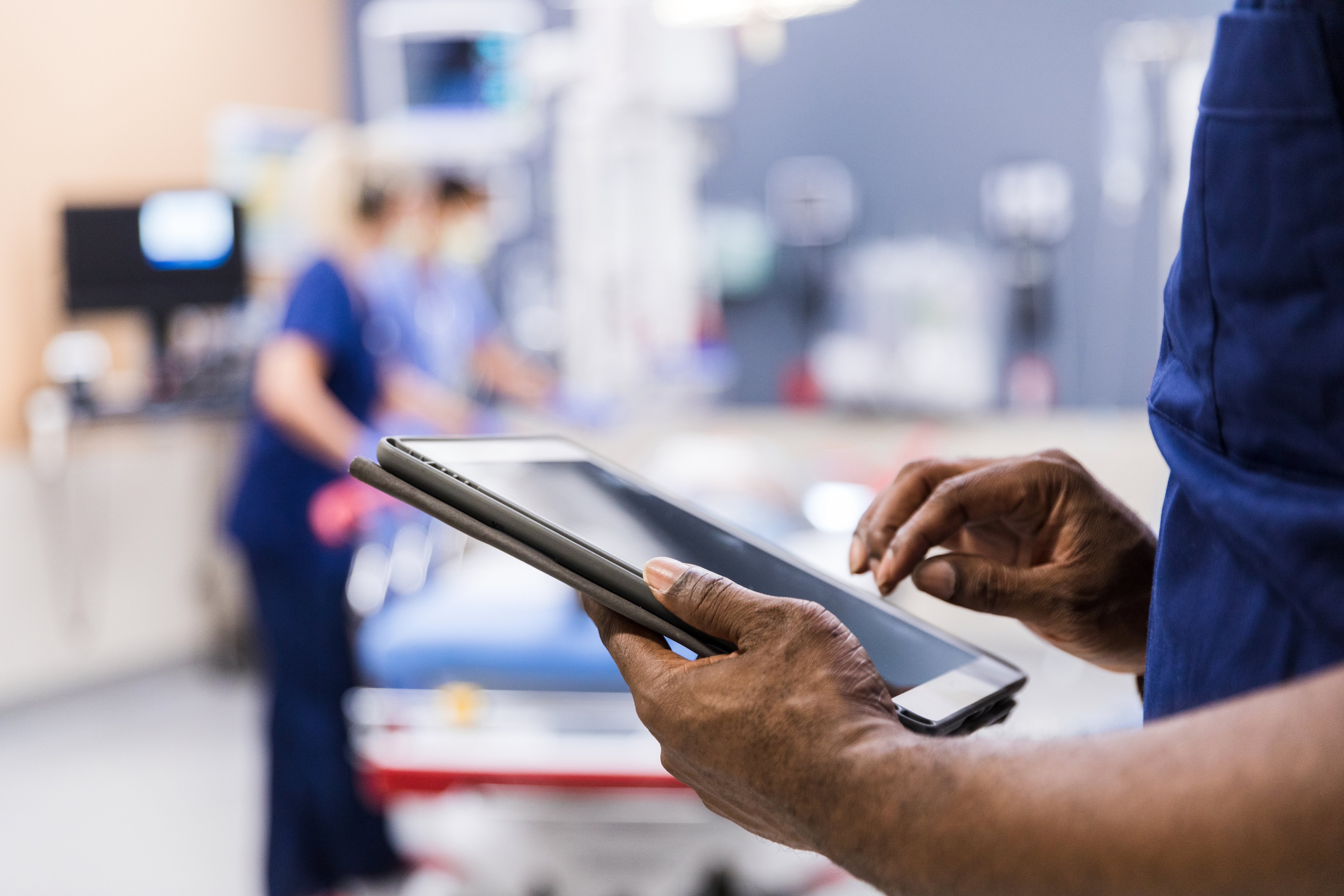 A clinician uses a tablet