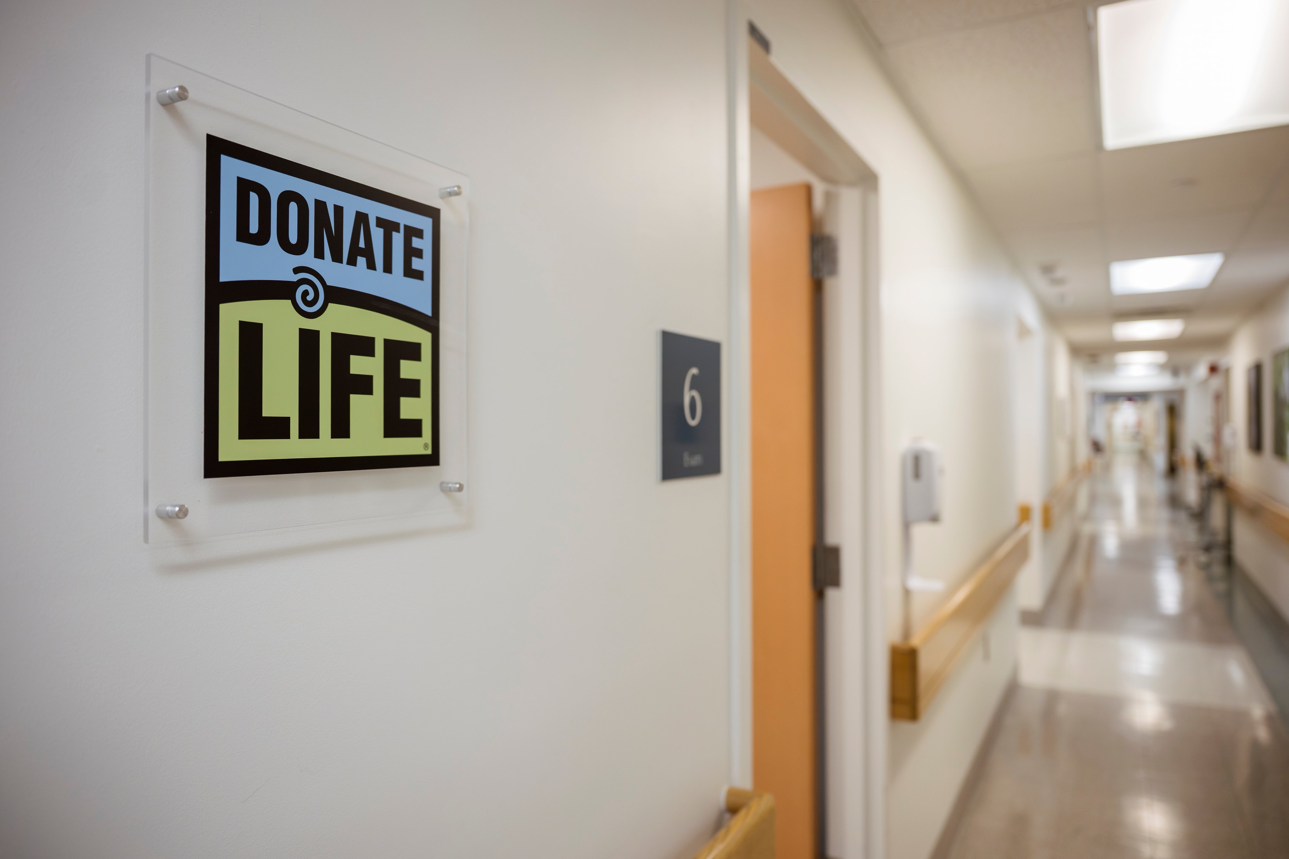 A hallway in the medical center with a Donate Life sign on the wall