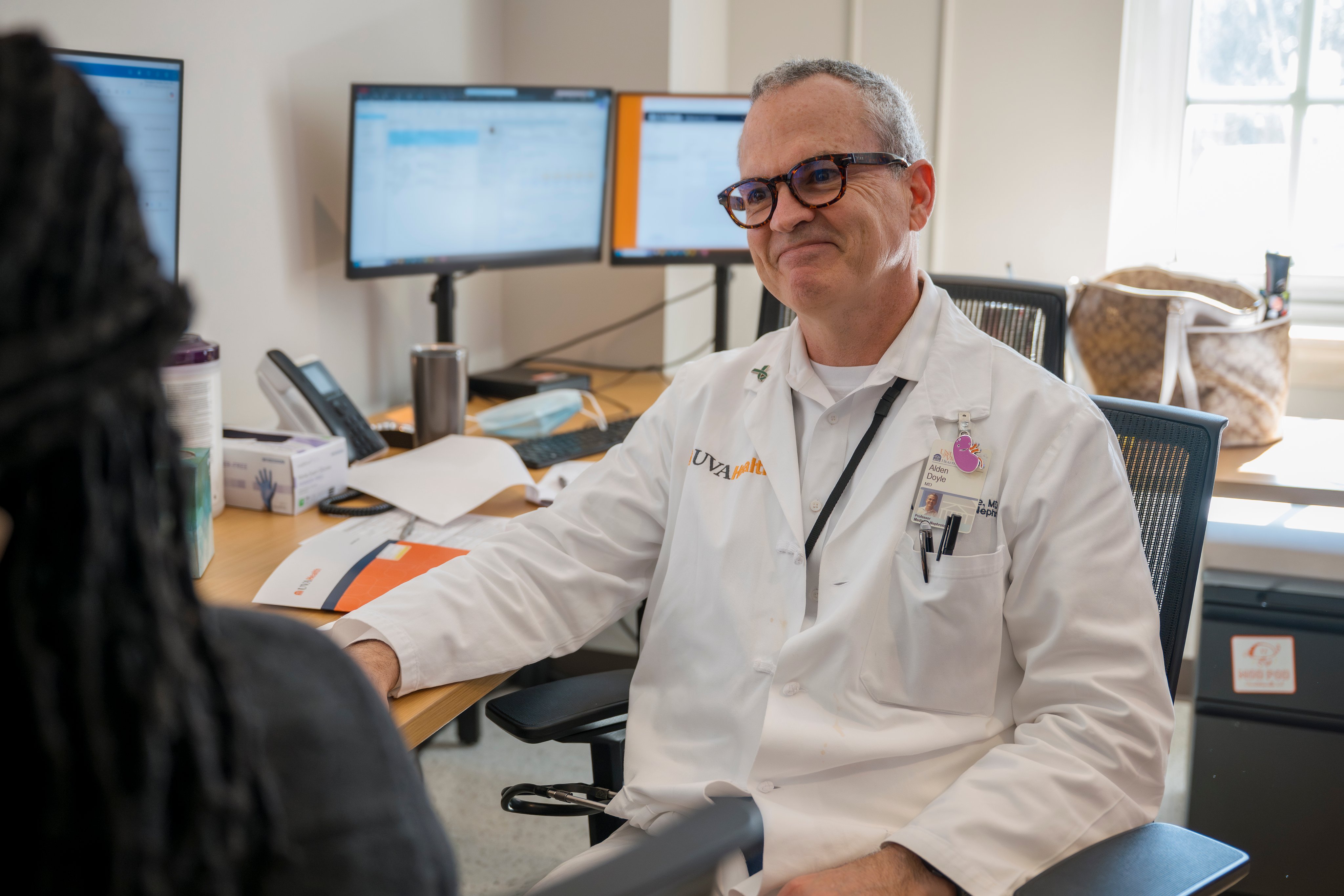 Dr. Alden Doyle in staff work room collaborating with colleague