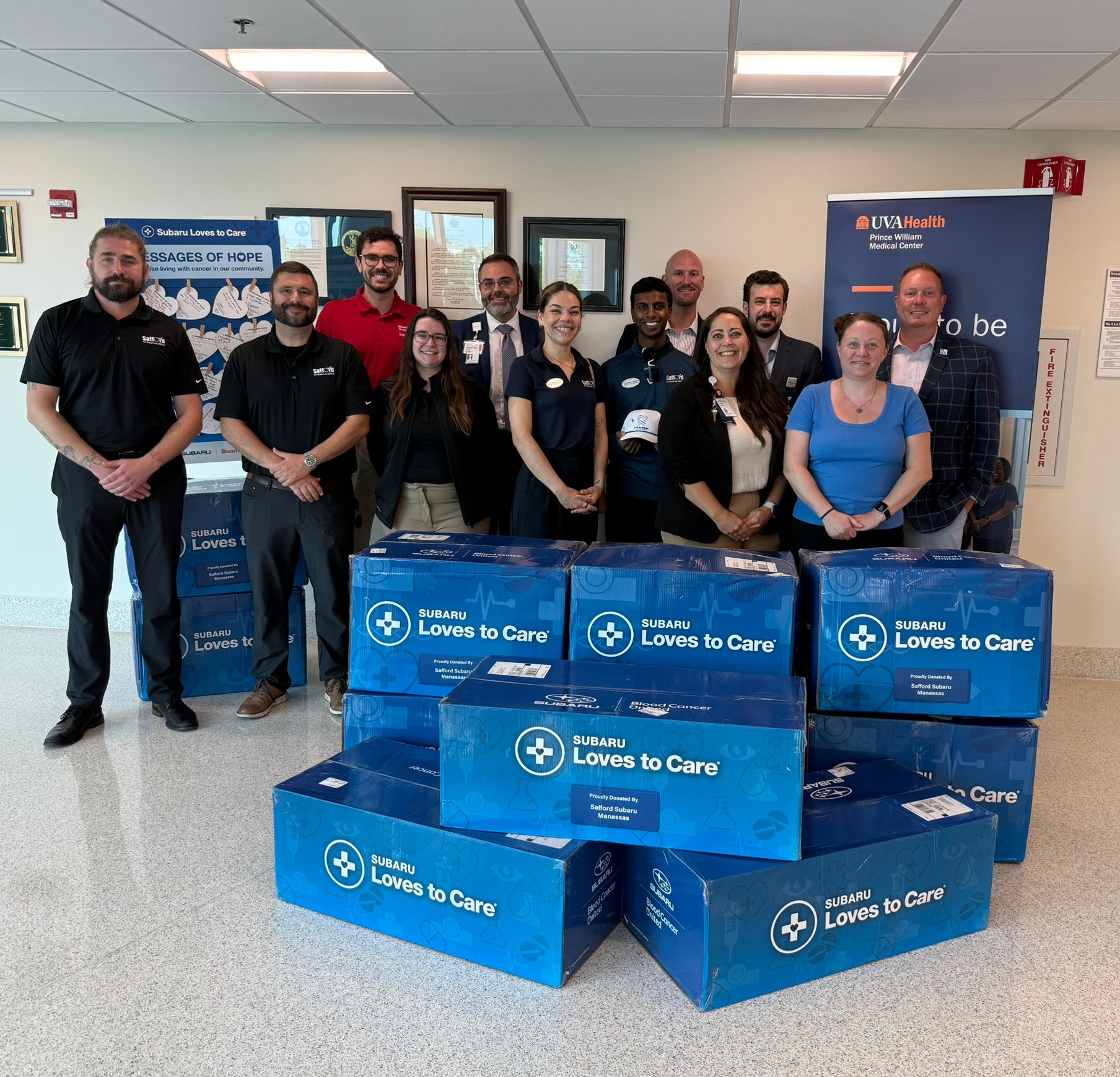 Safford Subaru team and staff from UVA Health gathered in a picture behind donation boxes
