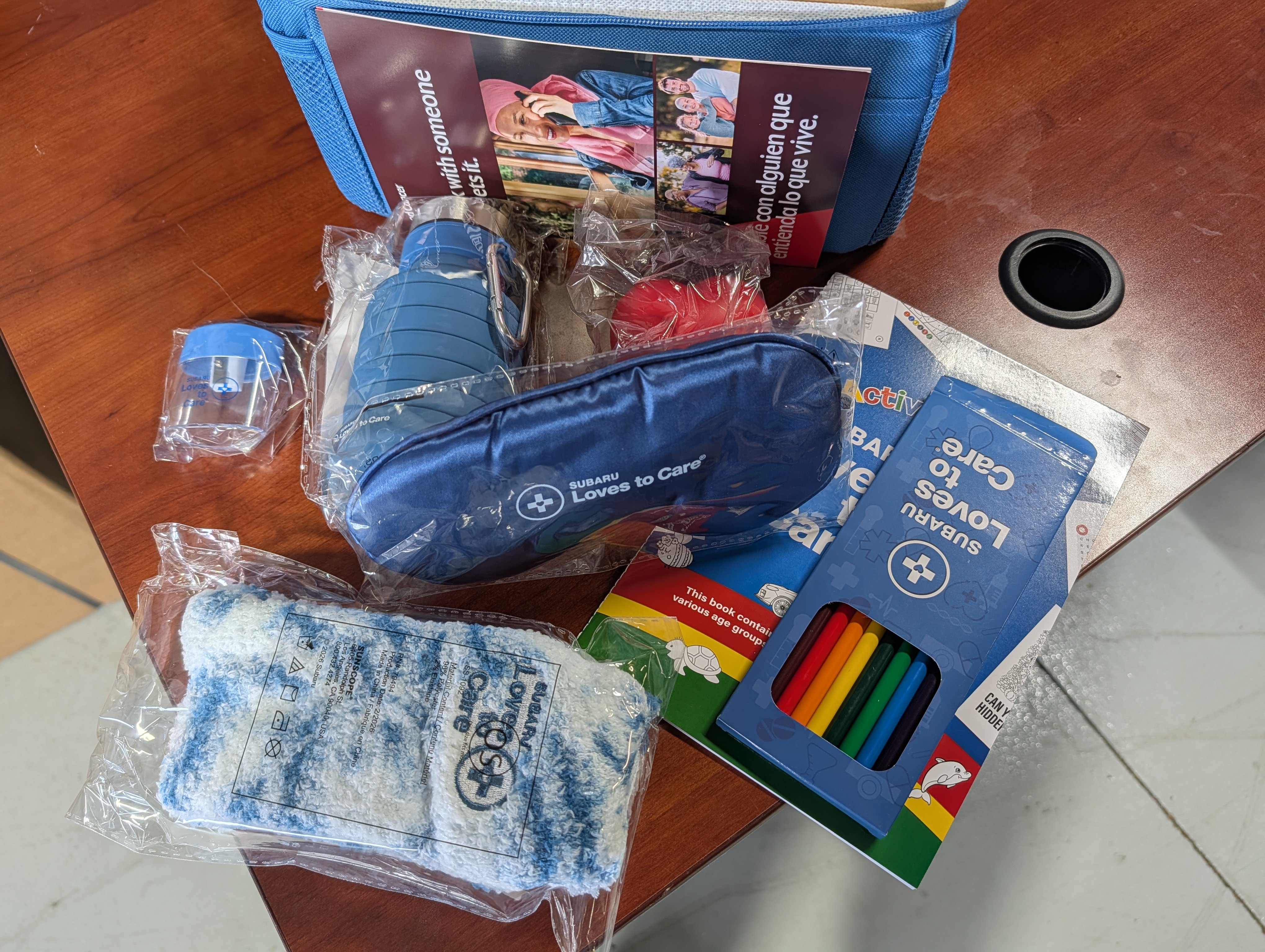 Items donated in Subaru Loves to Care(R) bag; socks, eye mask, colored pencils and more