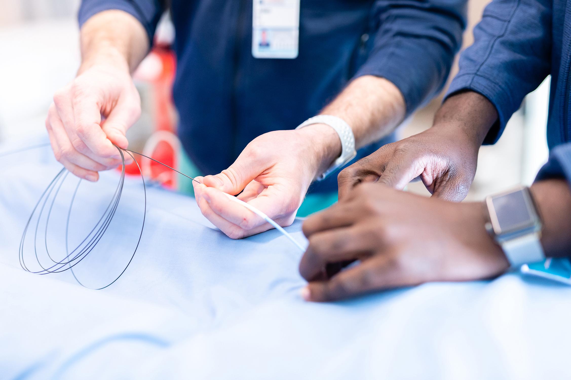 Two doctors working together on a surgery simulation
