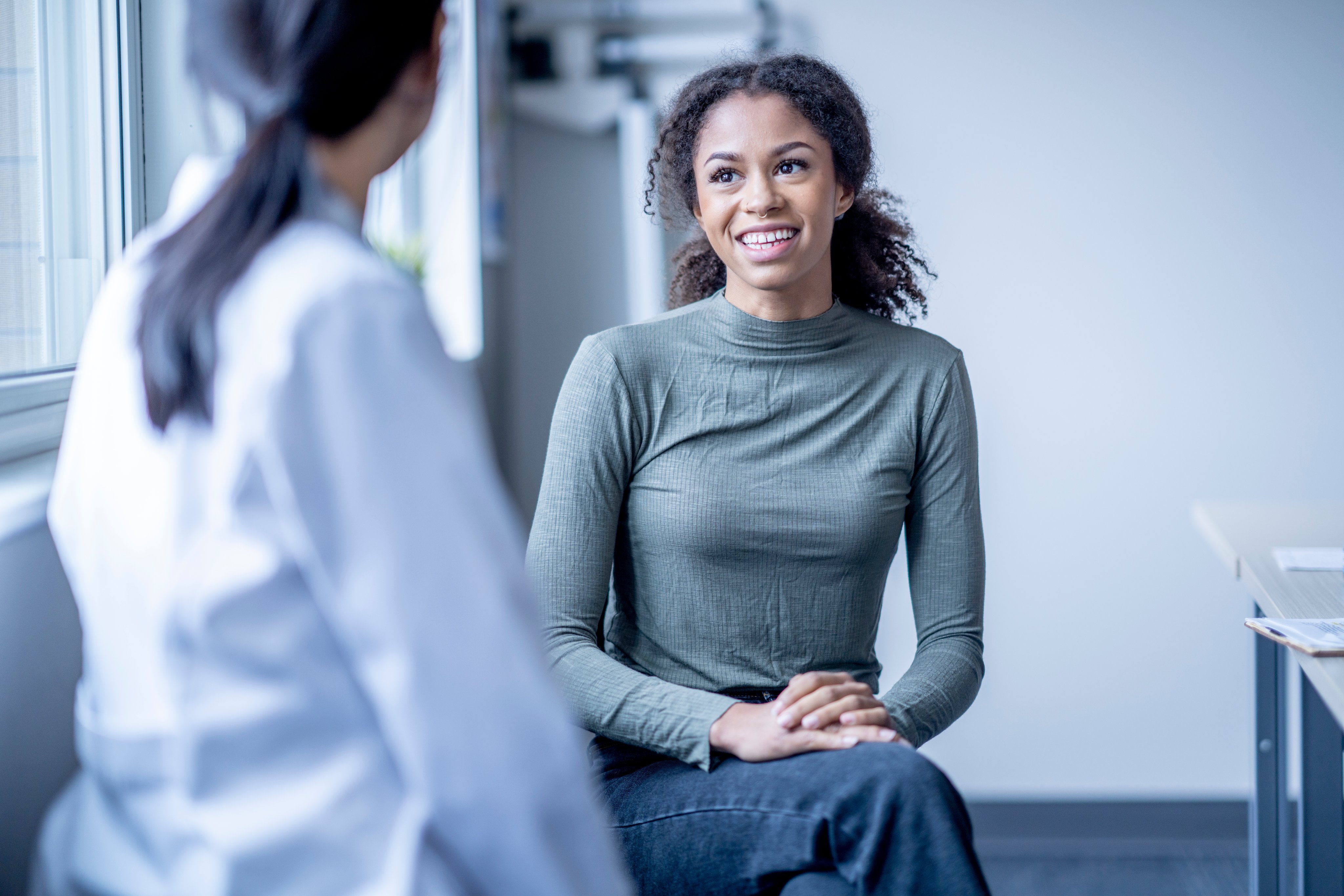 A woman talks with a provider