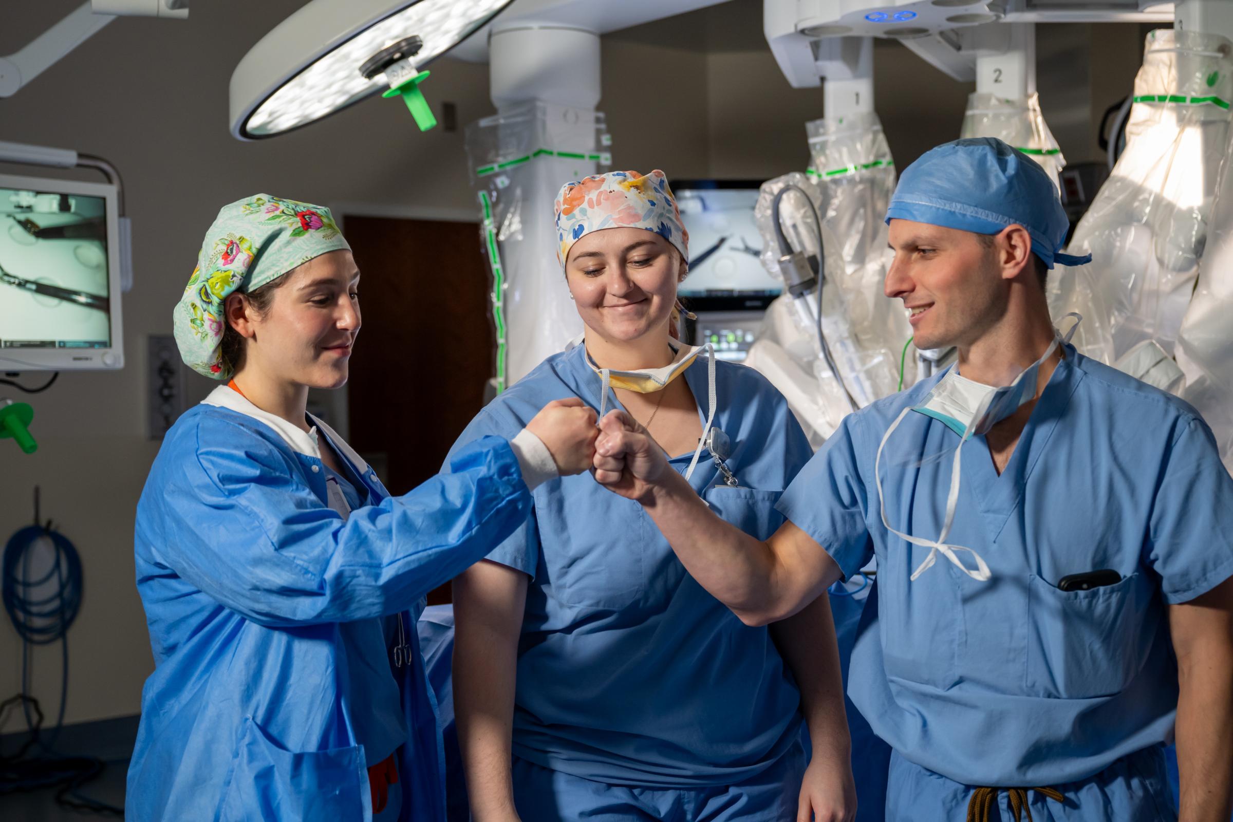 Providers fist bumping in the perating room
