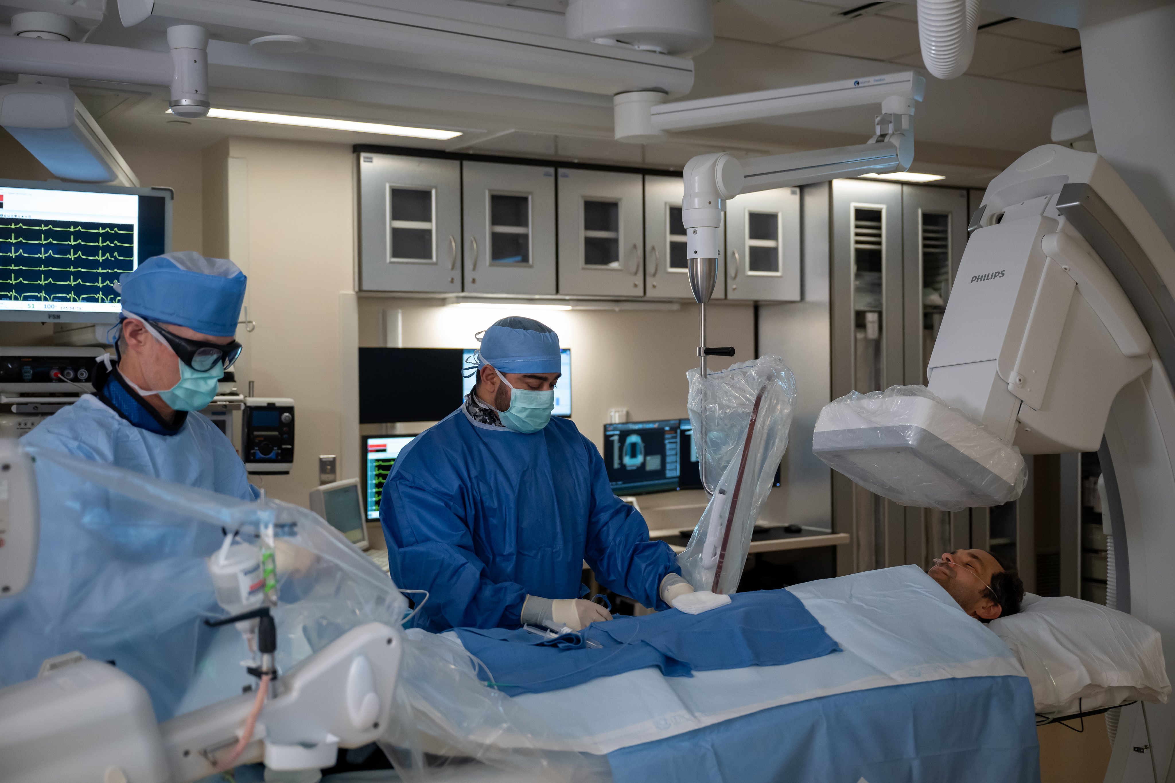 Two providers on UVA Health's Heart & Vascular Institute team working on a patient's heart condition